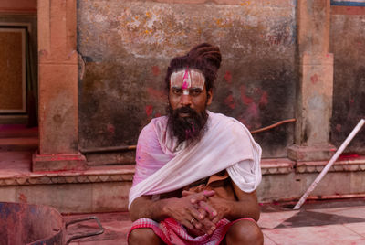 Portrait of young man sitting outdoors