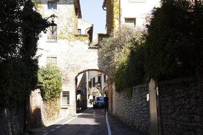 Footpath amidst buildings in city