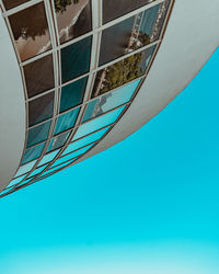 Low angle view of modern building against blue sky