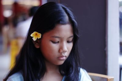 Close-up of girl wearing flower
