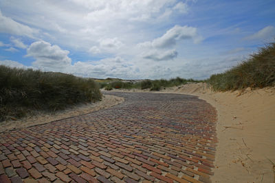 Scenic view of sand against sky