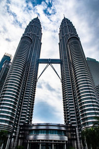 Low angle view of buildings against cloudy sky