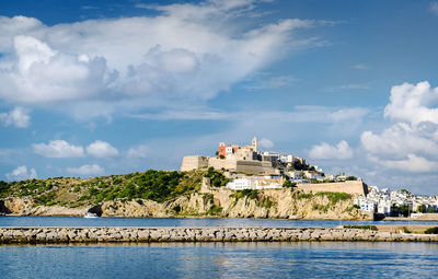 Castle by sea against sky