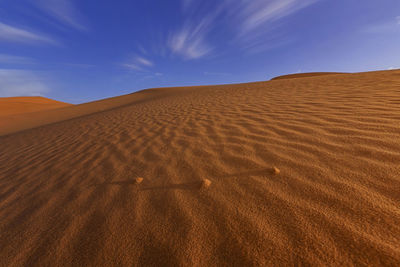 Scenic view of desert against sky during sunset