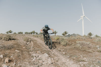 Spain, lanzarote, mountainbiker on a trip in desertic landscape