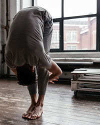 A man with strong body engaged in yoga and meditation, performing asanas