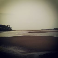 Scenic view of beach against clear sky