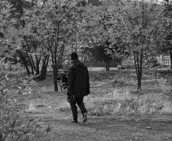 Rear view of man walking on footpath