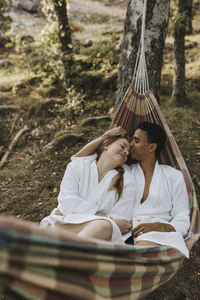 Couple relaxing in hammock