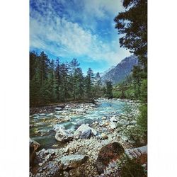 Scenic view of mountains against cloudy sky