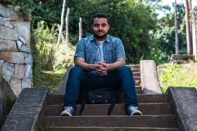 Portrait of smiling man sitting outdoors