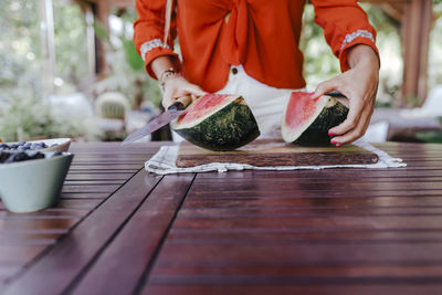 Close-up of man preparing food on table