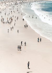 Crowd at beach on sunny day