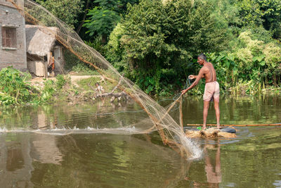 Man standing by lake