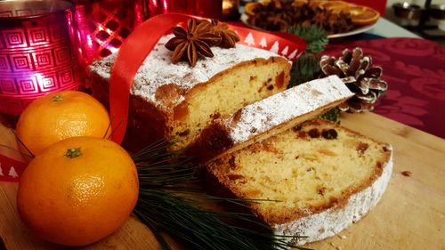 High angle view of cake with orange and pine cones on table during christmas