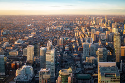 Aerial view of cityscape against sky during sunset