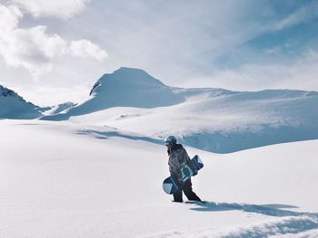 Full length of person on snowcapped mountain against sky