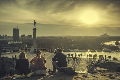 People sitting at observation point against sky