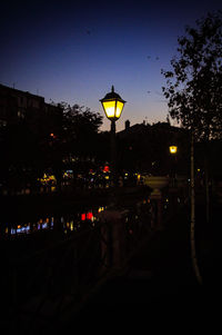 Illuminated street lights and buildings in city at night