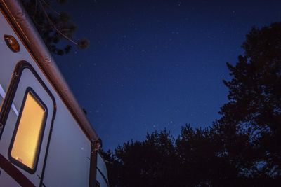 Low angle view of travel trailer against star field at night