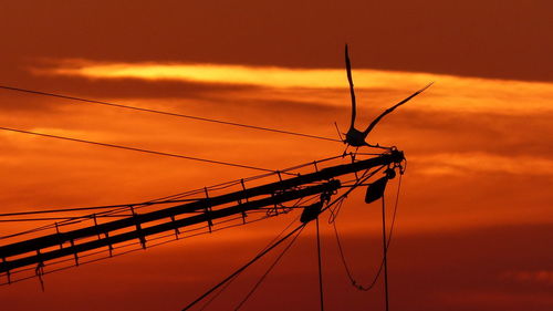 Silhouette of sailboat against sky during sunset