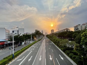 Road by city against sky