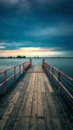 Pier over sea against sky