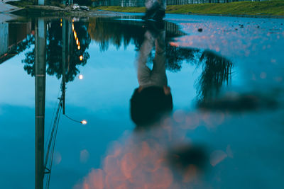 Reflection of man in puddle 