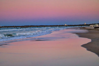 Scenic view of beach against sky during sunset