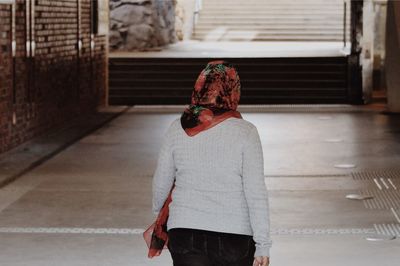 Rear view of woman standing against red umbrella in winter