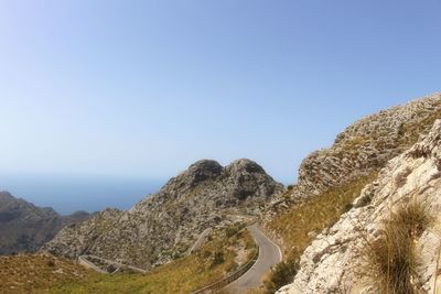 Scenic view of mountains against clear blue sky