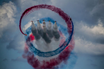 Low angle view of airshow against sky