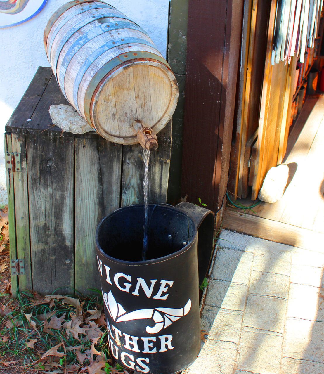 text, drink, western script, food and drink, close-up, communication, container, rusty, still life, metal, old, no people, wood - material, day, outdoors, table, abandoned, built structure, weathered, refreshment