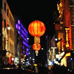 Illuminated lanterns in city at night