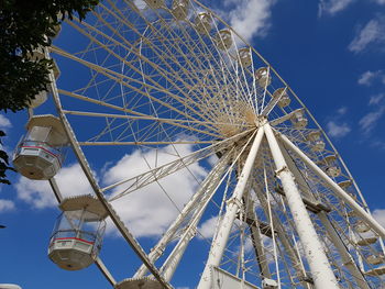 Low angle view of ferris wheel against sky