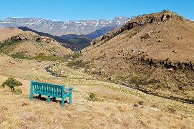 Scenic view of field and mountains against sky