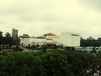 Buildings against cloudy sky