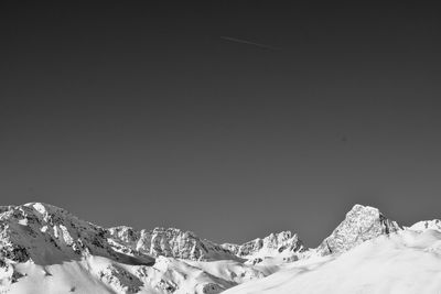 Scenic view of snowcapped mountains against clear sky