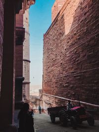 People on street amidst buildings in city