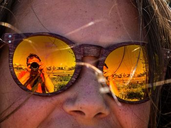 Close-up of woman with reflection on sunglasses