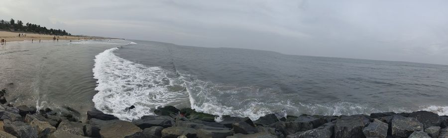 Panoramic shot of sea shore against sky