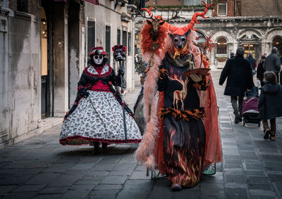 Rear view of woman wearing traditional clothing dancing on street