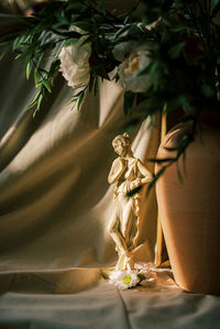 Persephone figure, soaking in the dramatic warm light.