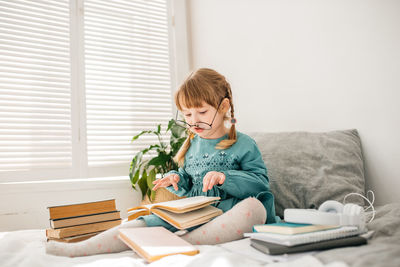 Girl reading book at home