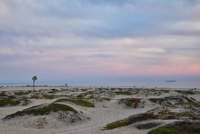 Scenic view of beach against sky during sunset