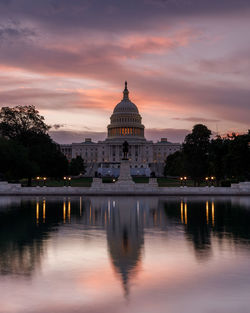 Reflection of building in water at sunset