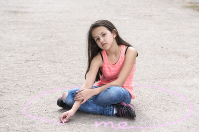 Portrait of girl sitting on street