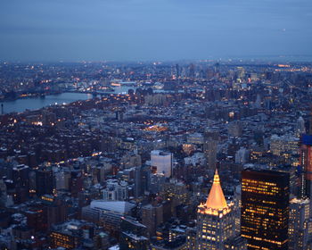 Aerial view of illuminated cityscape at dusk