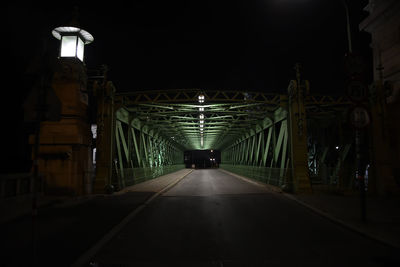 Empty illuminated footpath at night