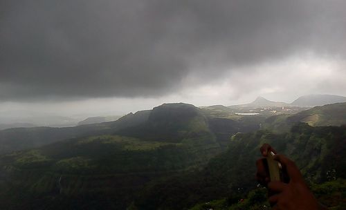 Scenic view of mountains against cloudy sky